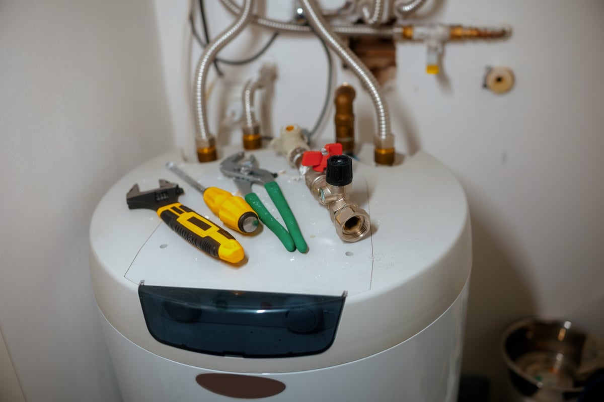 Plumber repairing water heater